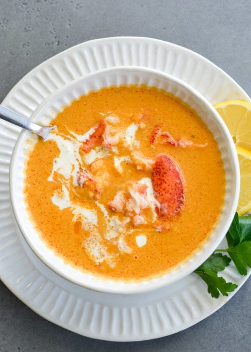 This creamy Lobster Bisque is a shortcut recipe that is low on carbs, but big on flavor! This 30 minute soup recipe features a savory broth and garlic butter lobster for a truly decadent meal! 