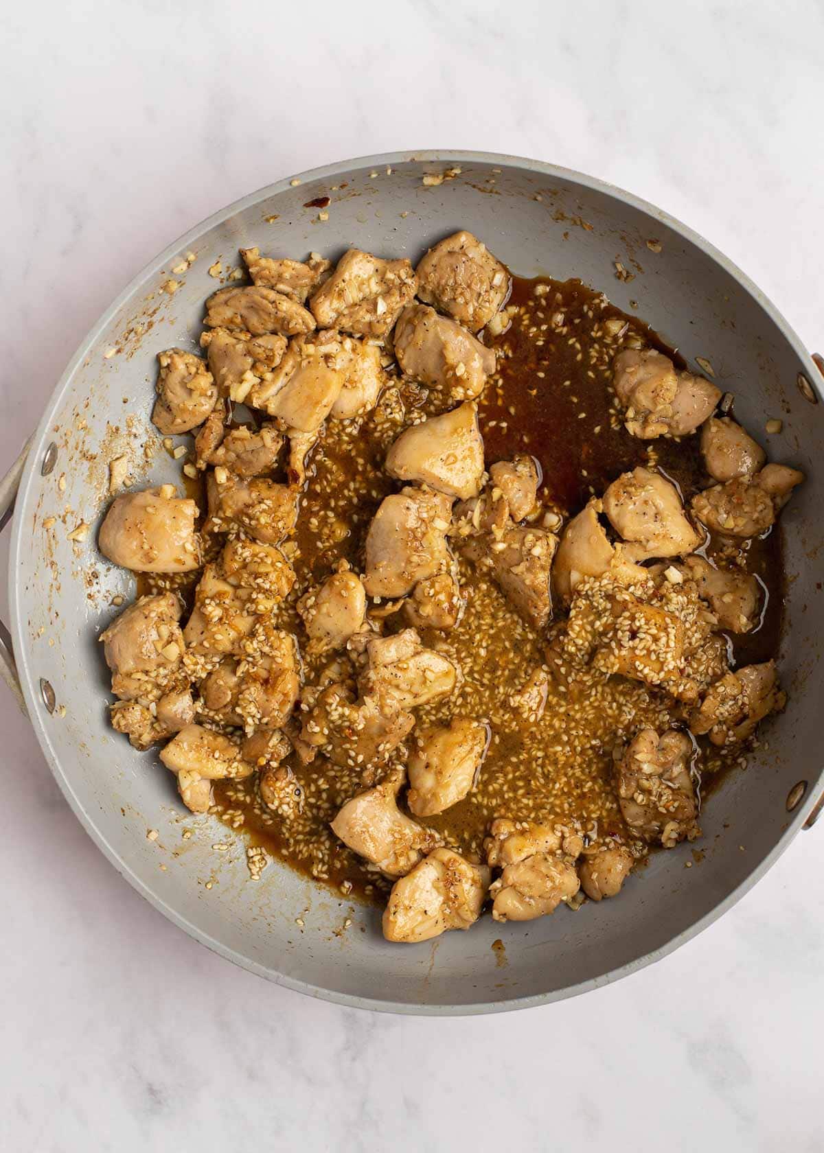 stir fry sauce and chicken in skillet