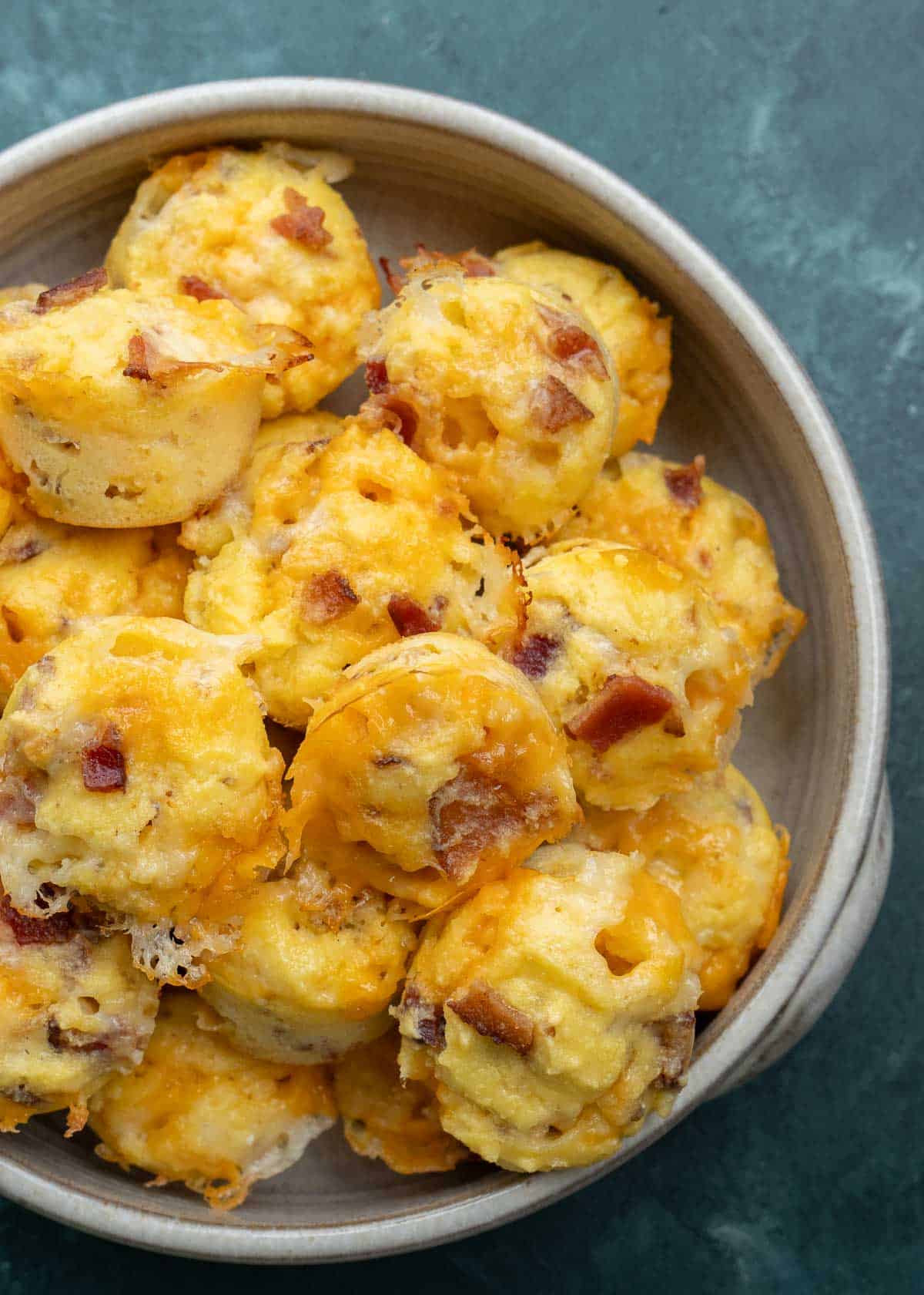 Bacon egg and cheese muffins on a white plate