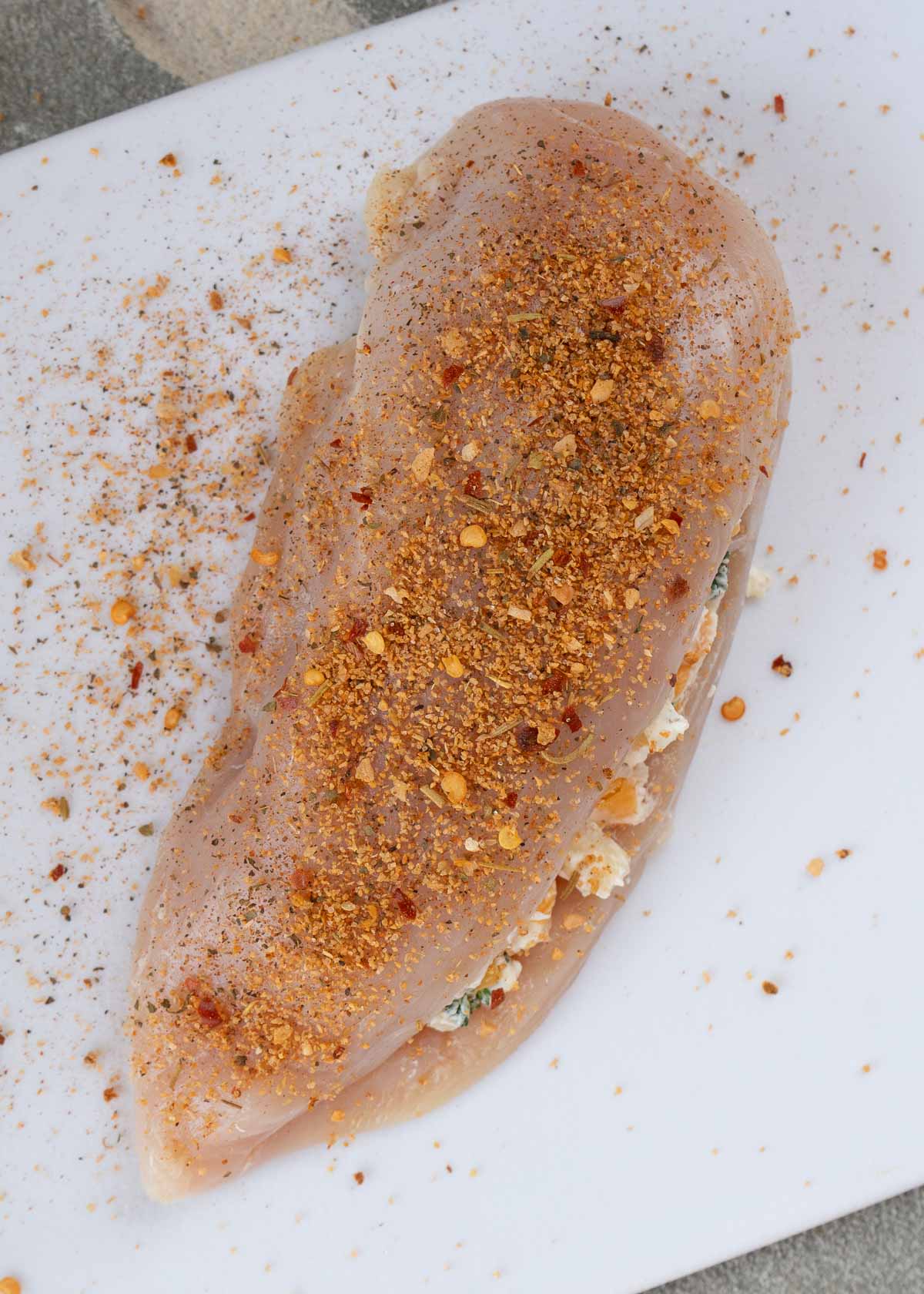 cajun seasoning sprinkled on butterflied and stuffed chicken breast