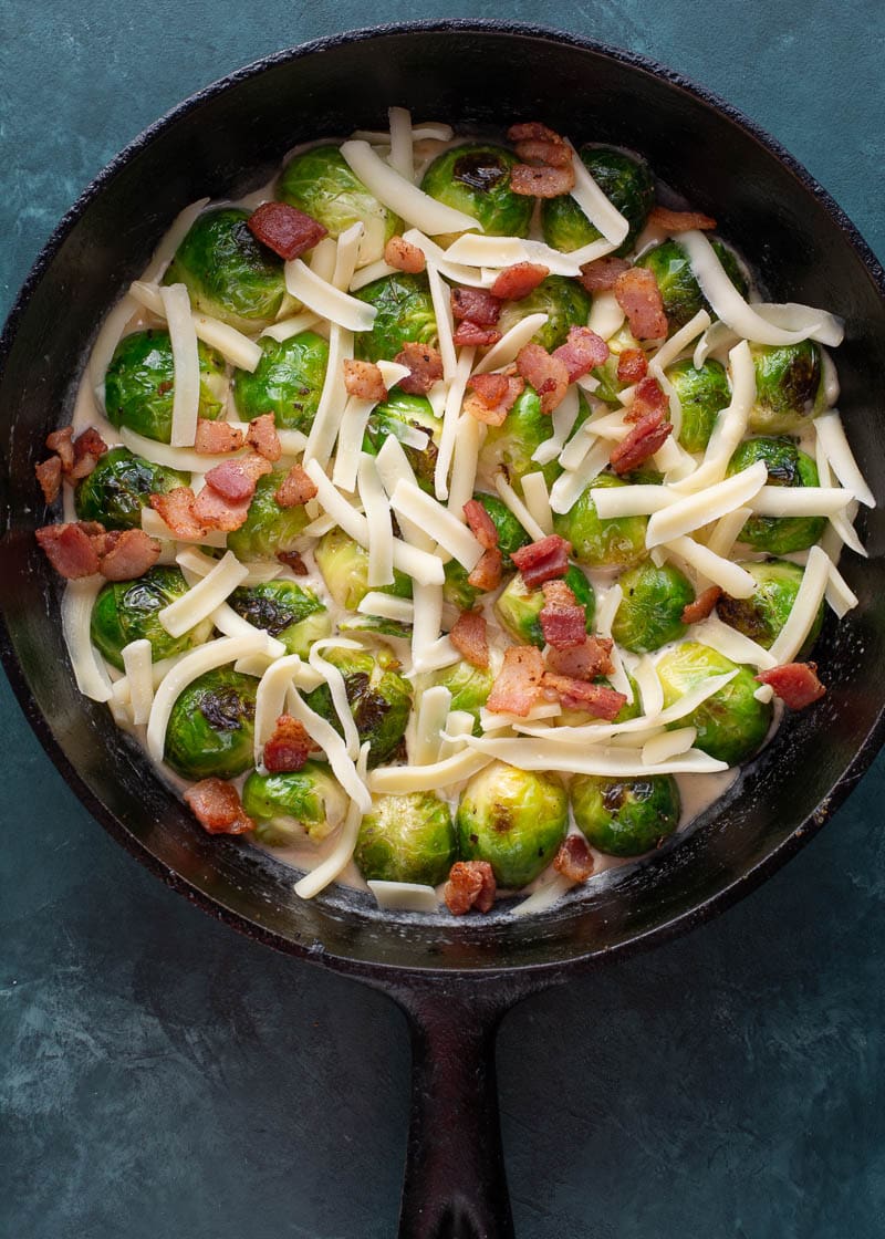 These Cheesy Brussels Sprouts with Bacon are made in one pan and perfect for entertaining! This easy vegetable side dish is low carb and keto-friendly! 