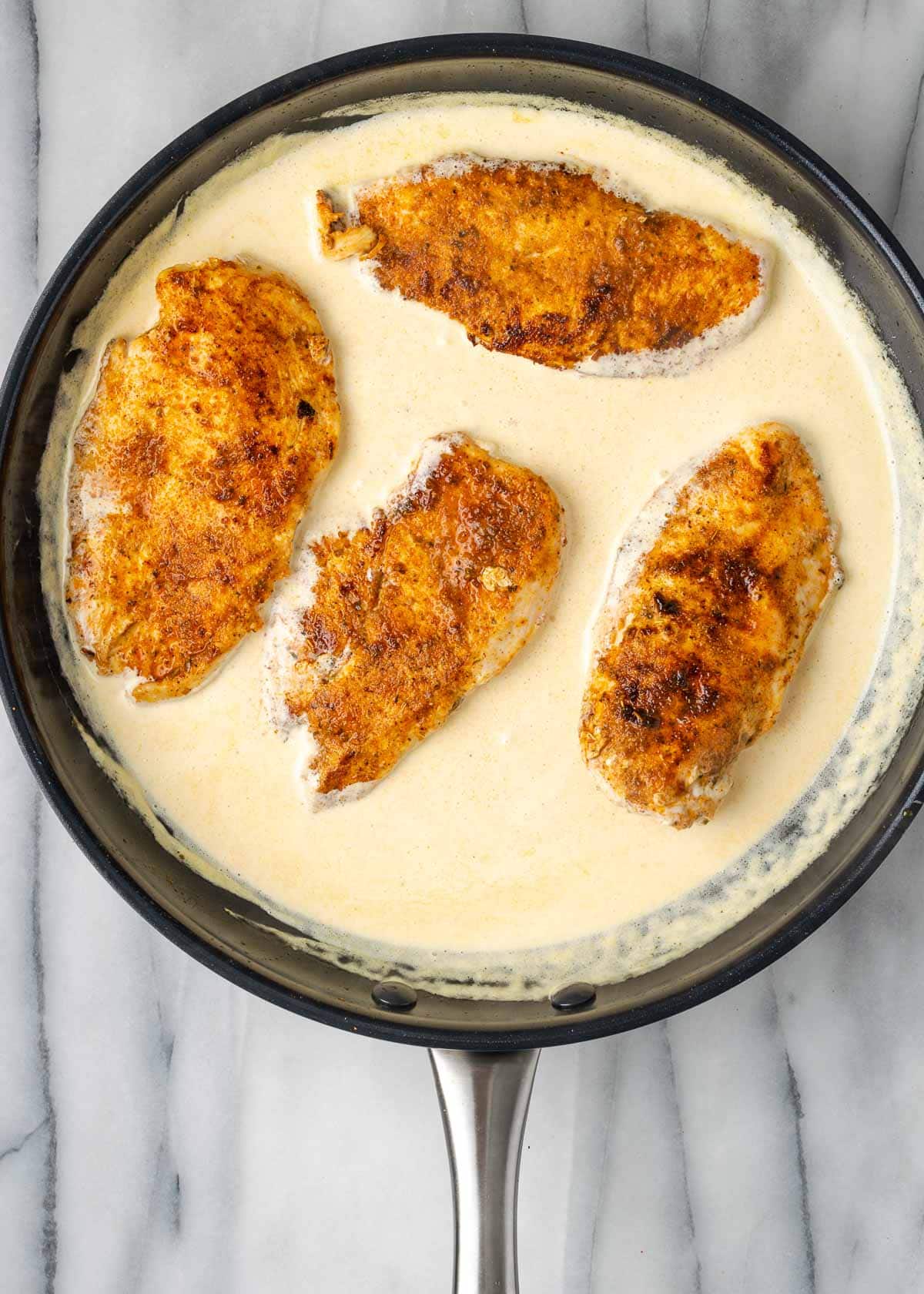 cream sauce and chicken in skillet