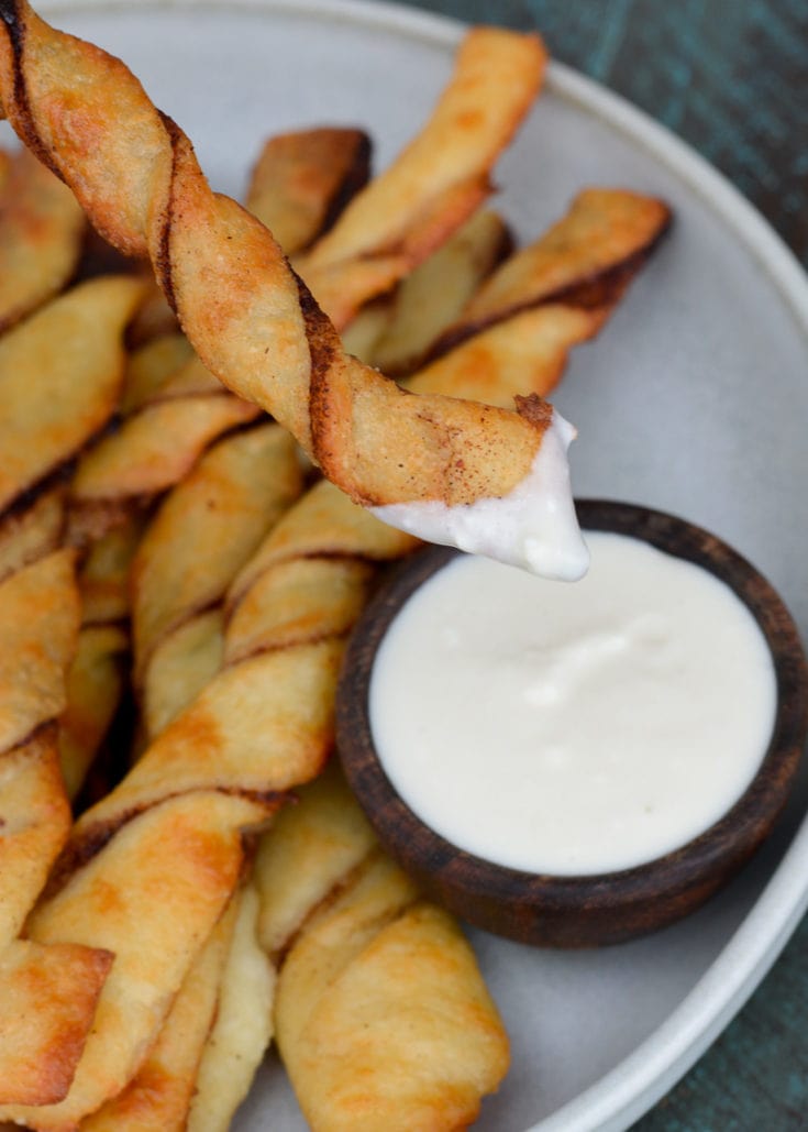 These easy Keto Cinnamon Twists have a delicious keto cream cheese dipping sauce for the best gluten free + keto snack! Enjoy two twists and frosting for about 3 net carbs.
