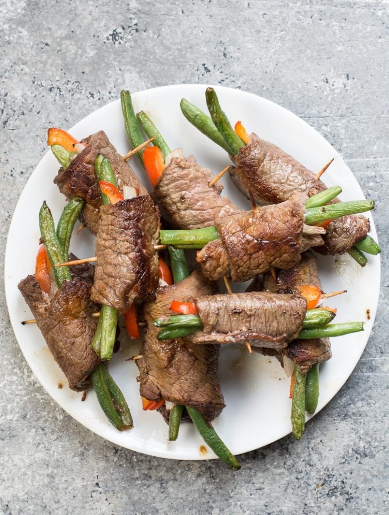 These steak rolls cook best if you do not over fill them. Generally, I fill these with roughly 2 of each. Two green beans, 2 very thin slices of bell pepper and onion. I find small slices of steak about 2 inches x 3 inches is just about perfect for that ratio. You can make this however you wish just remember if you make them thicker your cooking time will increase and if you fill these with more vegetables your carb count will increase if you are on keto.