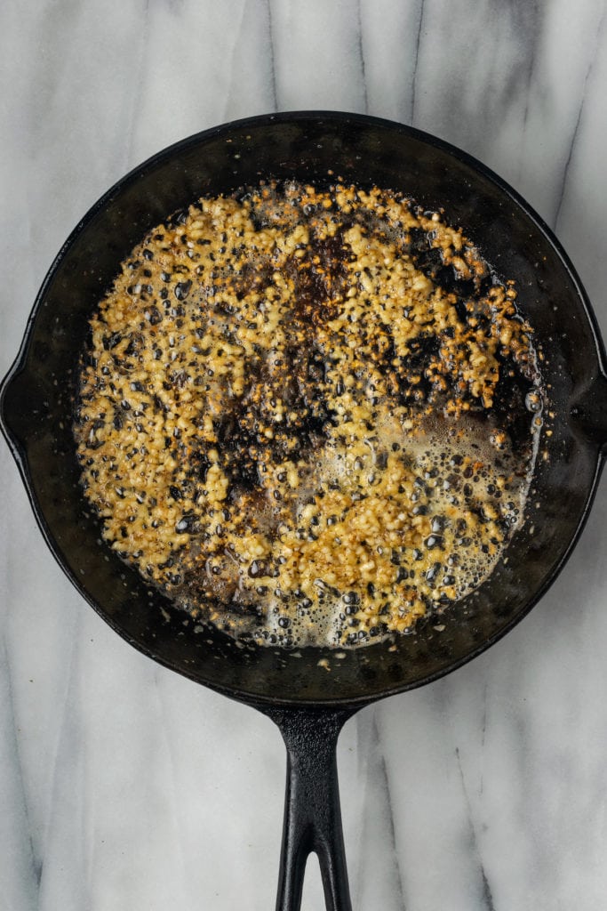 A skillet full of sauteed garlic