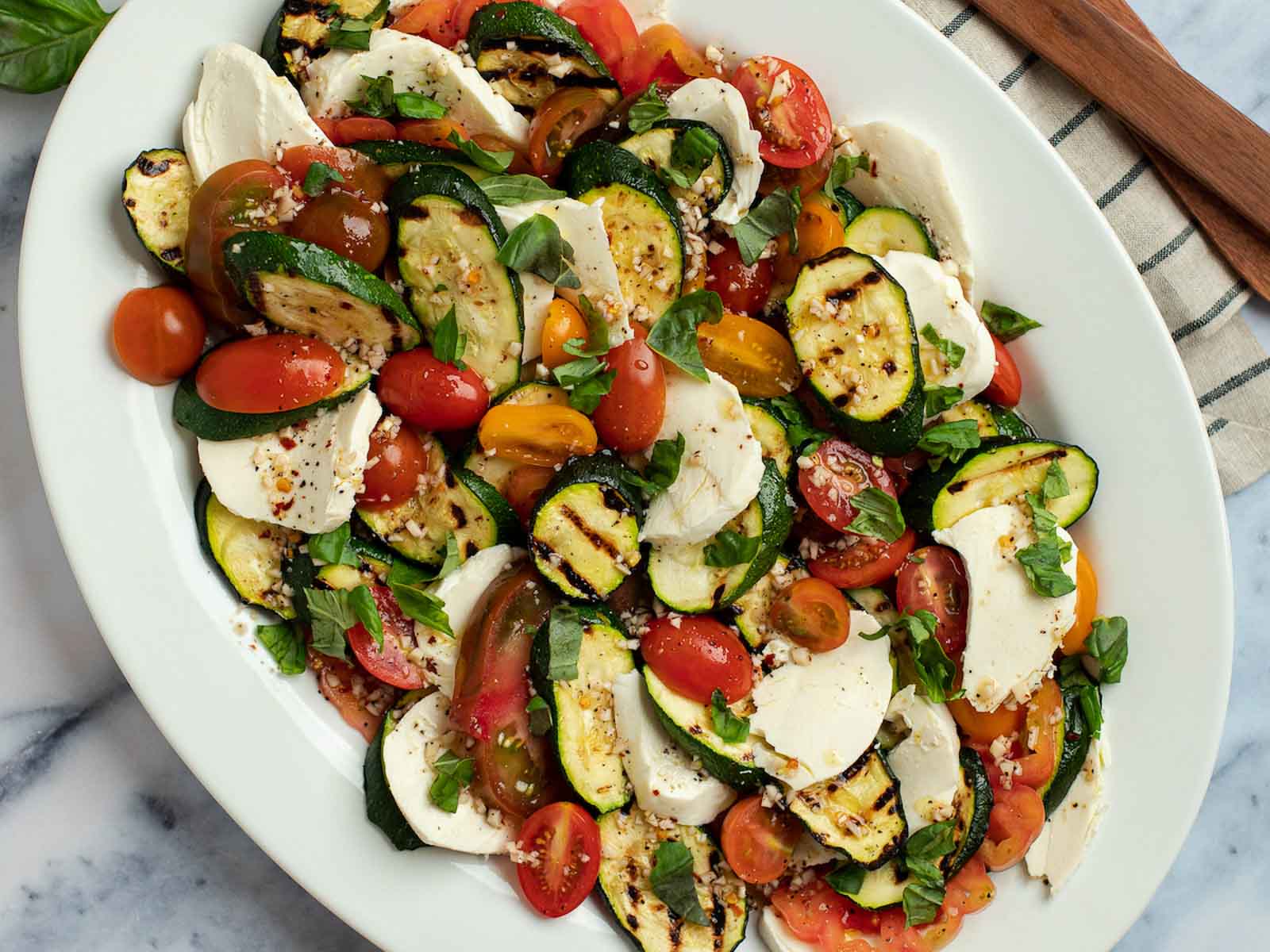 This Grilled Zucchini Salad with a homemade red wine vinaigrette will be your repeat meal of the summer! This healthy recipe is ready in under 30 minutes, loaded with fresh mozzarella and tender veggies, and has fewer than 5 net carbs.