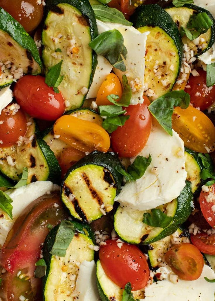 This Grilled Zucchini Salad with a homemade red wine vinaigrette will be your repeat meal of the summer! This healthy recipe is ready in under 30 minutes and loaded with fresh mozzarella and tender veggies.