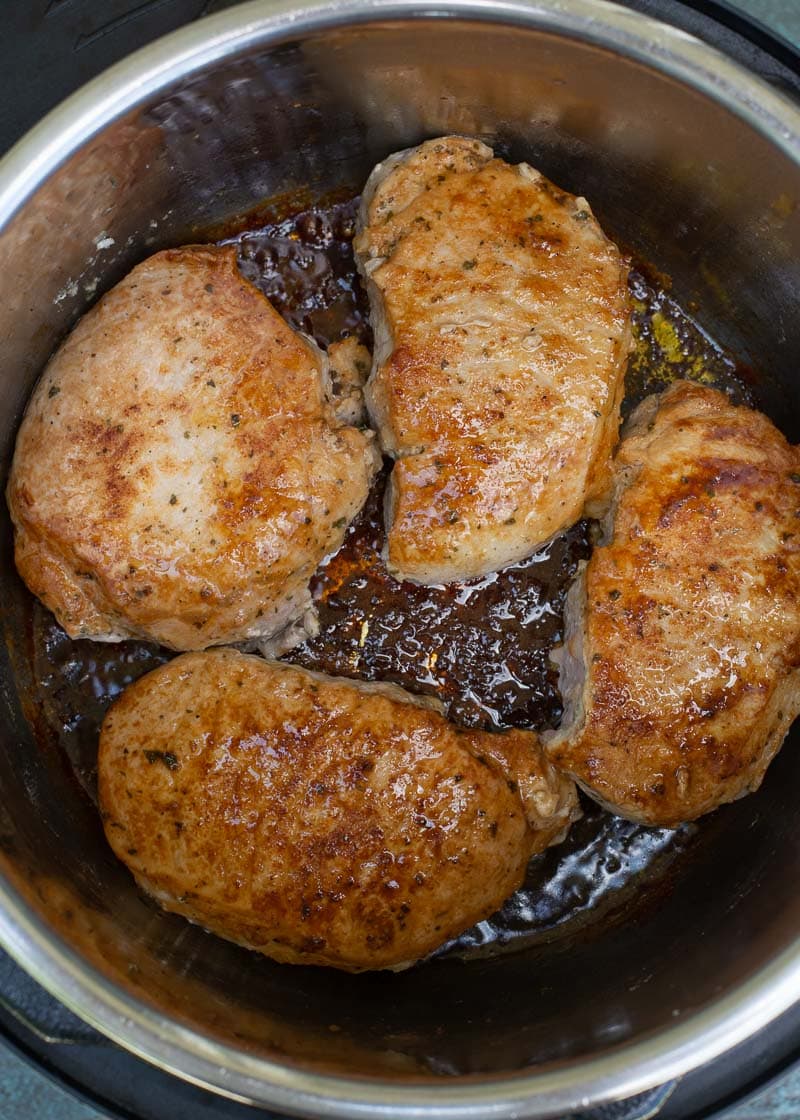 These easy Instant Pot Pork Chops require just 6 minutes of cook time! Seasoned and seared pork chops are perfectly tender and served with a savory gravy. This is a low carb meal your entire family will love!