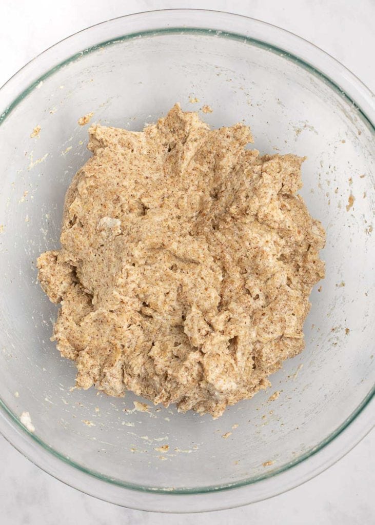 A mixing bowl with bread dough in it