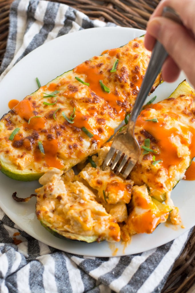 These easy Buffalo Chicken Zucchini Boats are loaded with chicken, cheese and spicy buffalo sauce! At only 4 net carbs per serving this will be your new favorite keto dinner!