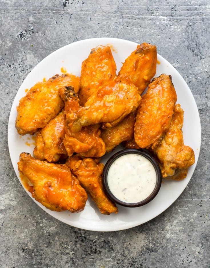These Keto Buffalo Wings are ultra crispy with no breading then covered in a buttery, tangy buffalo sauce! Only 2 net carbs per serving! #keto