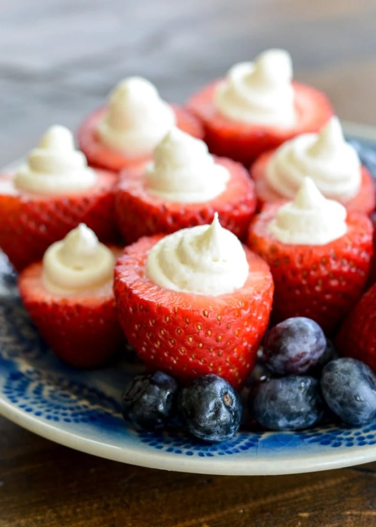 Simple no bake Keto Cheesecake Strawberries are the easiest low carb dessert! Enjoy four stuffed strawberries for about 5 net carbs! 