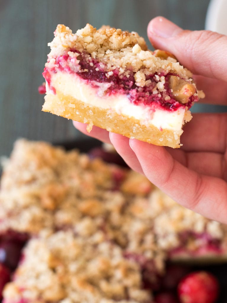 These delicious Keto Cranberry Cheesecake Bars have rich layers including an almond flour shortbread cookie crust, vanilla cheesecake, low carb cranberry sauce and a pecan crumble. At 5 net carbs each this is a decadent keto treat!