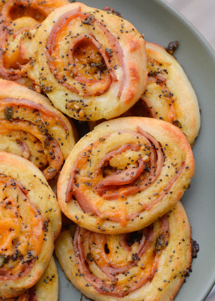 These Keto Ham and Cheese Rolls are smothered in a garlic poppy seed sauce you will love! These savory, low carb rolls come to just under 2 net carbs each!