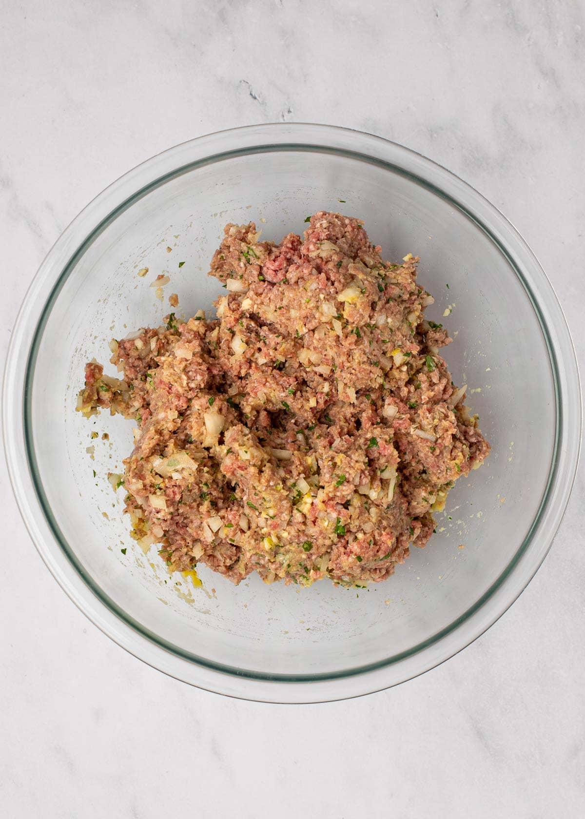 Overhead view of a mixing bowl filled with meatloaf mixture