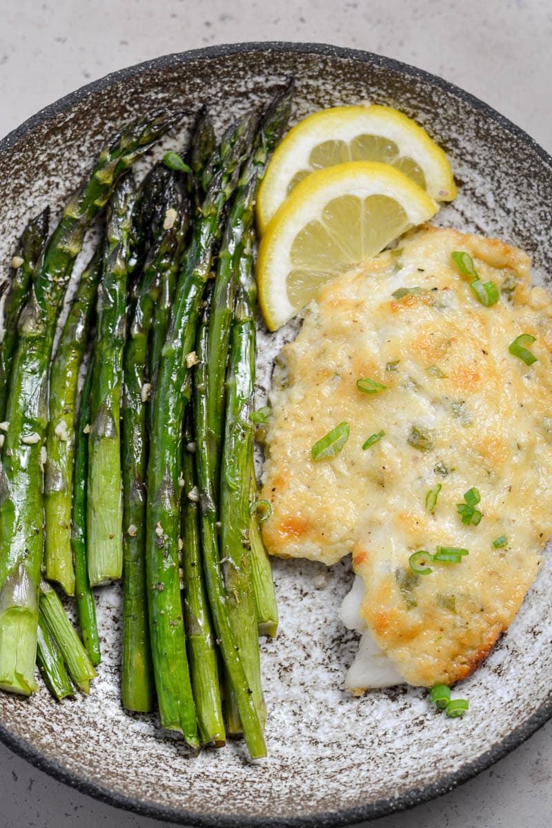 This Keto Parmesan Tilapia and Asparagus is the perfect low carb recipe for one! At only 3.8 net carbs per serving this 20 minute meal is the perfect keto recipe for busy nights!