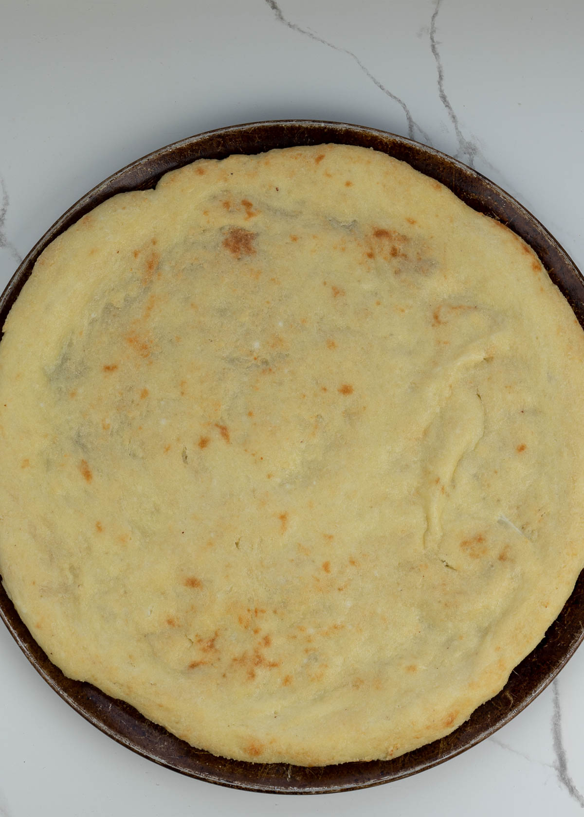 Follow this step by step guide to make the BEST Keto Pizza Crust Recipe! This crust is made from a fat head dough base and is low carb, grain and gluten free!