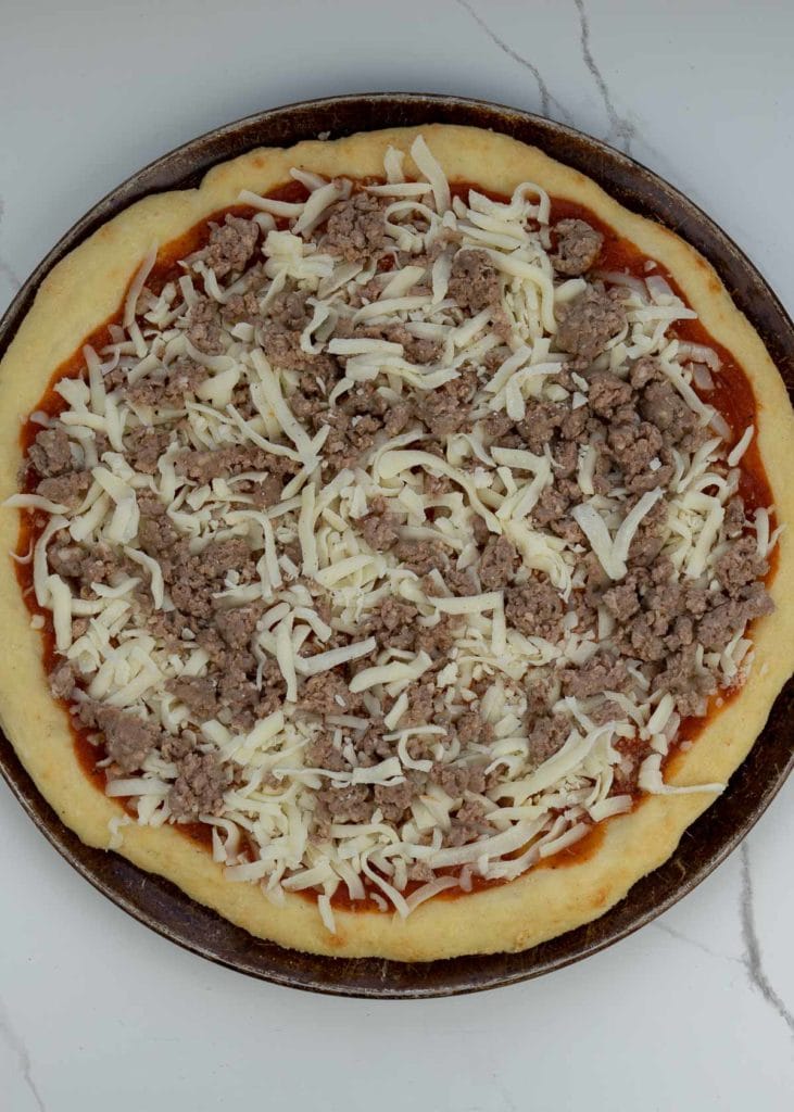 This step-by-step guide will show you exactly how to make the best Keto Pizza Recipe! This low carb pizza crust is crispy and delicious! Enjoy a slice of this keto pizza for about 3 net carbs!