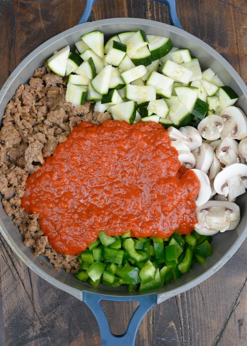 Keto Pizza is the perfect easy dinner recipe! This low carb dinner is packed with Italian sausage, zucchini, peppers, marinara and cheese!