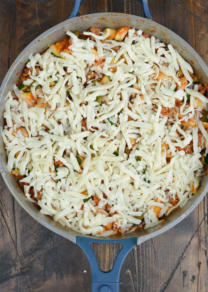 Keto Pizza is the perfect easy dinner recipe! This low carb dinner is packed with Italian sausage, zucchini, peppers, marinara and cheese!