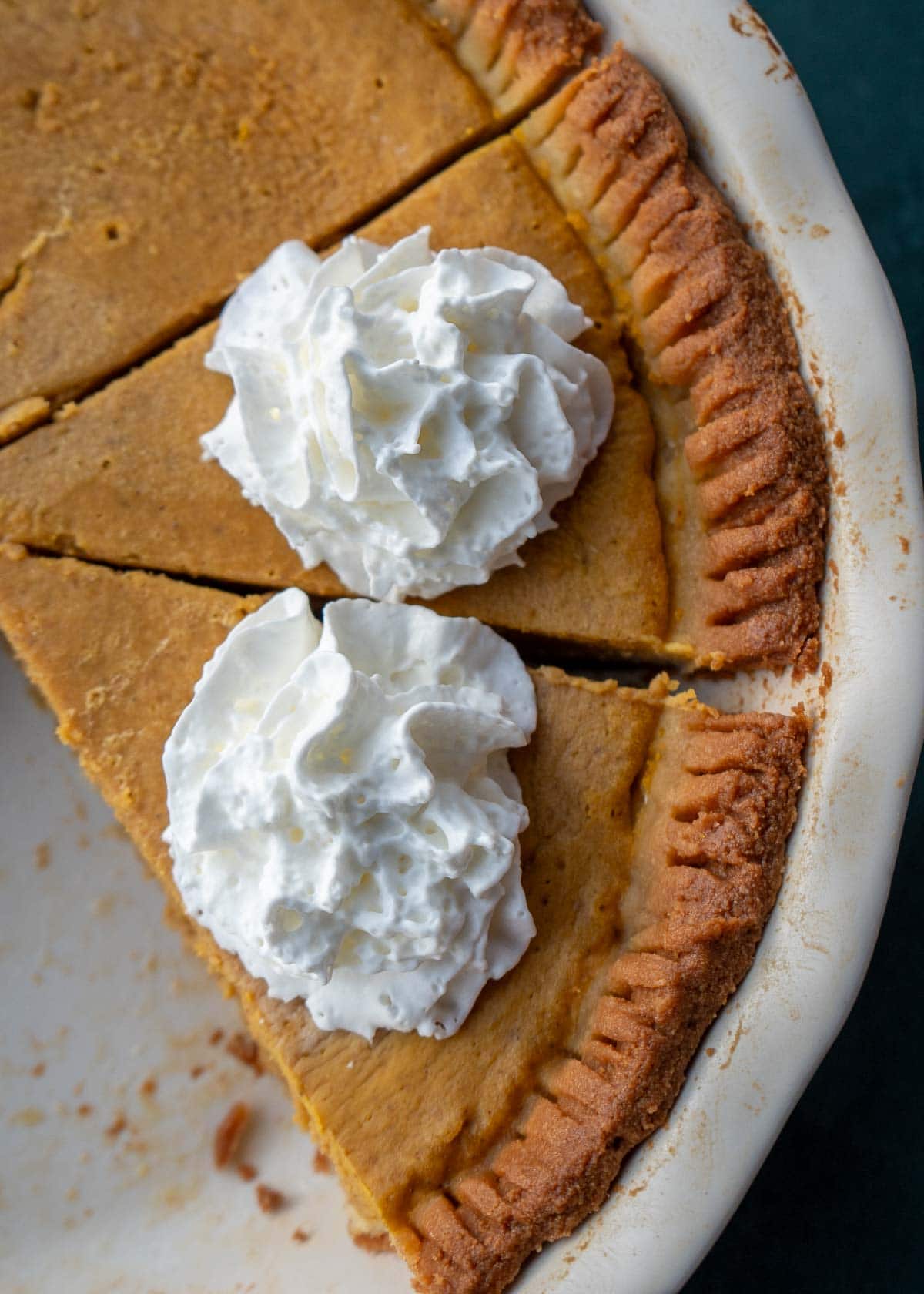 an overheads shot of pumpkin pie with whipped cream