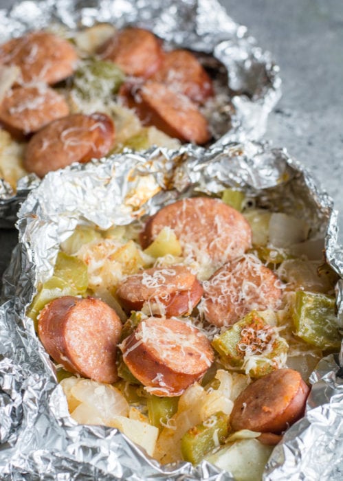 Keto Sausage and Cabbage Foil Packs are loaded with spicy sausage, bell pepper, onion, and cabbage in a cajun butter sauce! A perfect low carb meal for camping or grilling out! #keto