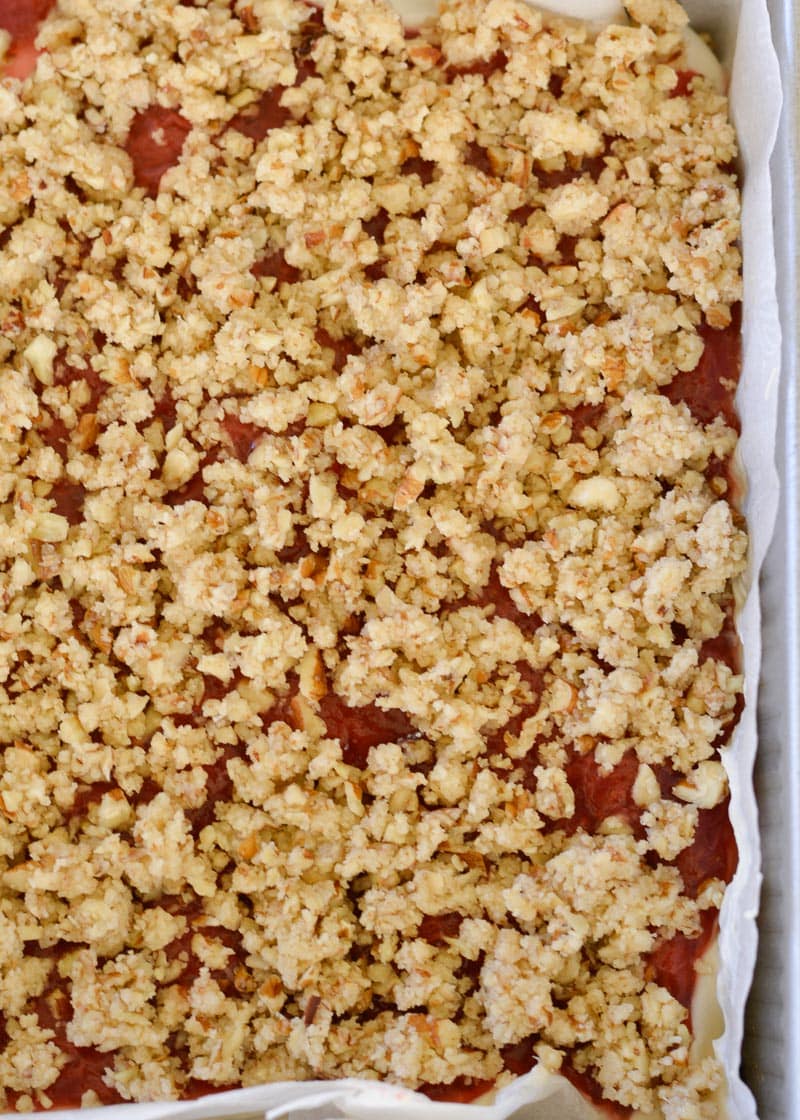 These Keto Strawberry Cheesecake Bars have a decadent buttery shortbread crust, delicious vanilla cheesecake with low carb strawberry sauce and are topped with a pecan crumble! Under 5 carbs each, these bars are going to become your go-to keto dessert!