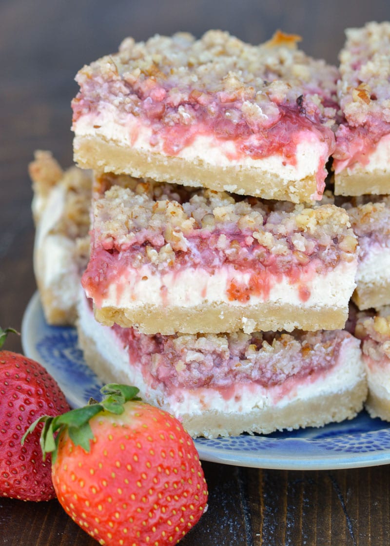 These Keto Strawberry Cheesecake Bars have a decadent buttery shortbread crust, delicious vanilla cheesecake with low carb strawberry sauce and are topped with a pecan crumble! Under 5 carbs each, these bars are going to become your go-to keto dessert!