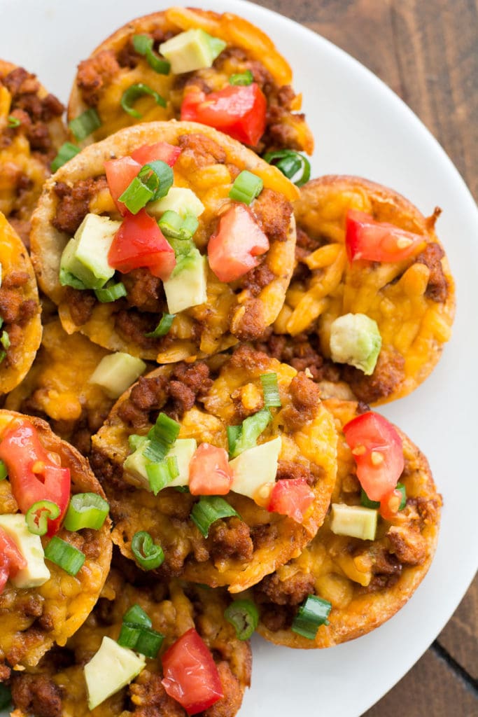 These easy Keto Taco Cups are made with low carb fat head dough, seasoned taco meat and cheddar cheese! Each cup is less than 2 net carbs and loaded with taco flavor! #keto