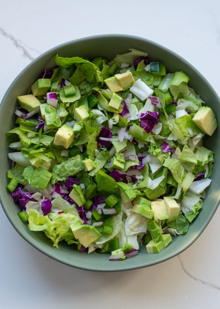 This easy Keto Taco Salad is easy, delicious, and healthy! Top your favorite greens with seasoned meat, tomato, avocado, peppers, and more for a lunch or dinner full of flavor and about 7 net carbs.