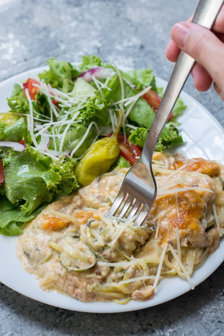 A portion of low carb tuna casserole on a plate with a side salad. 