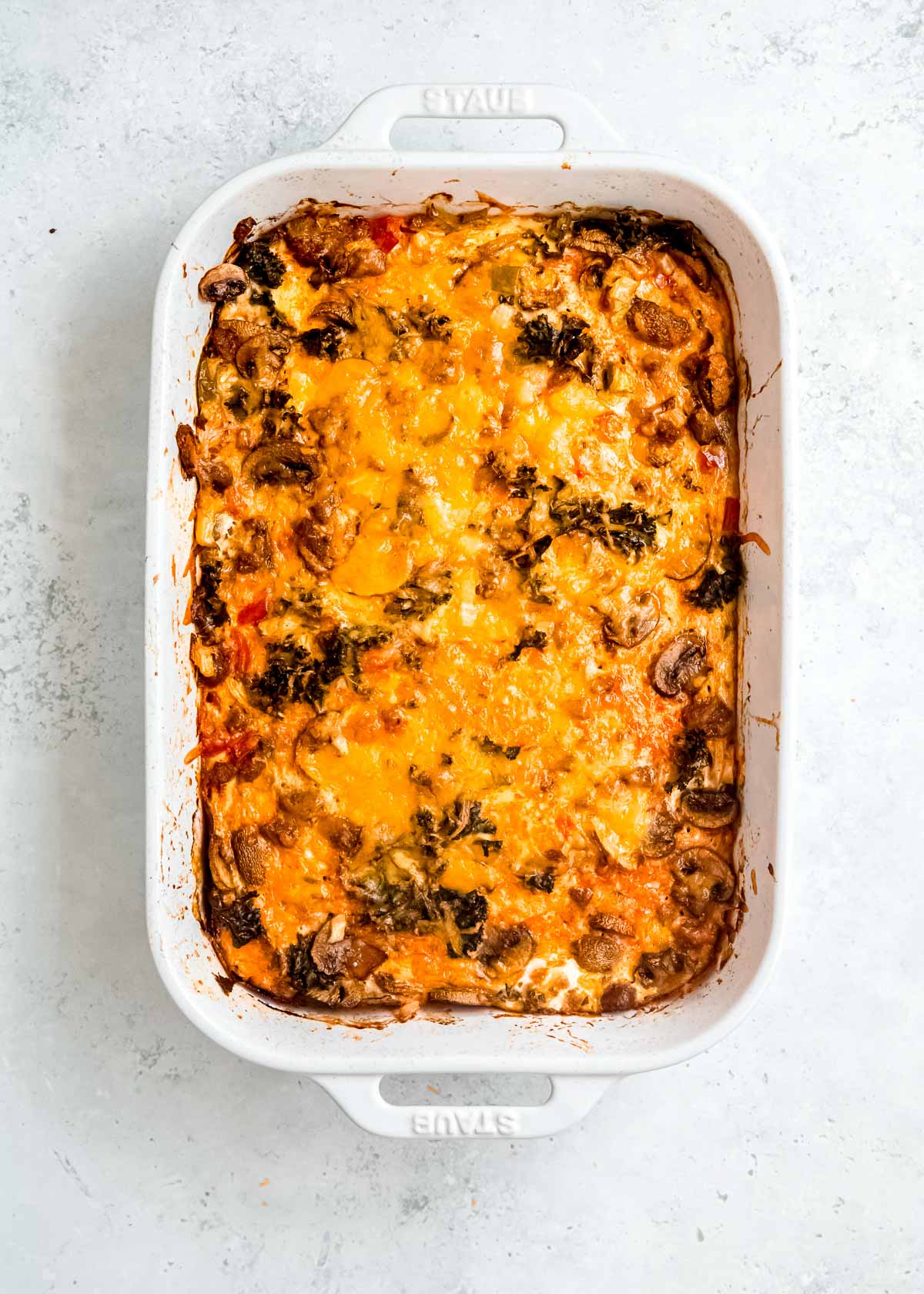 Cooked breakfast casserole in a white baking dish (overhead shot)