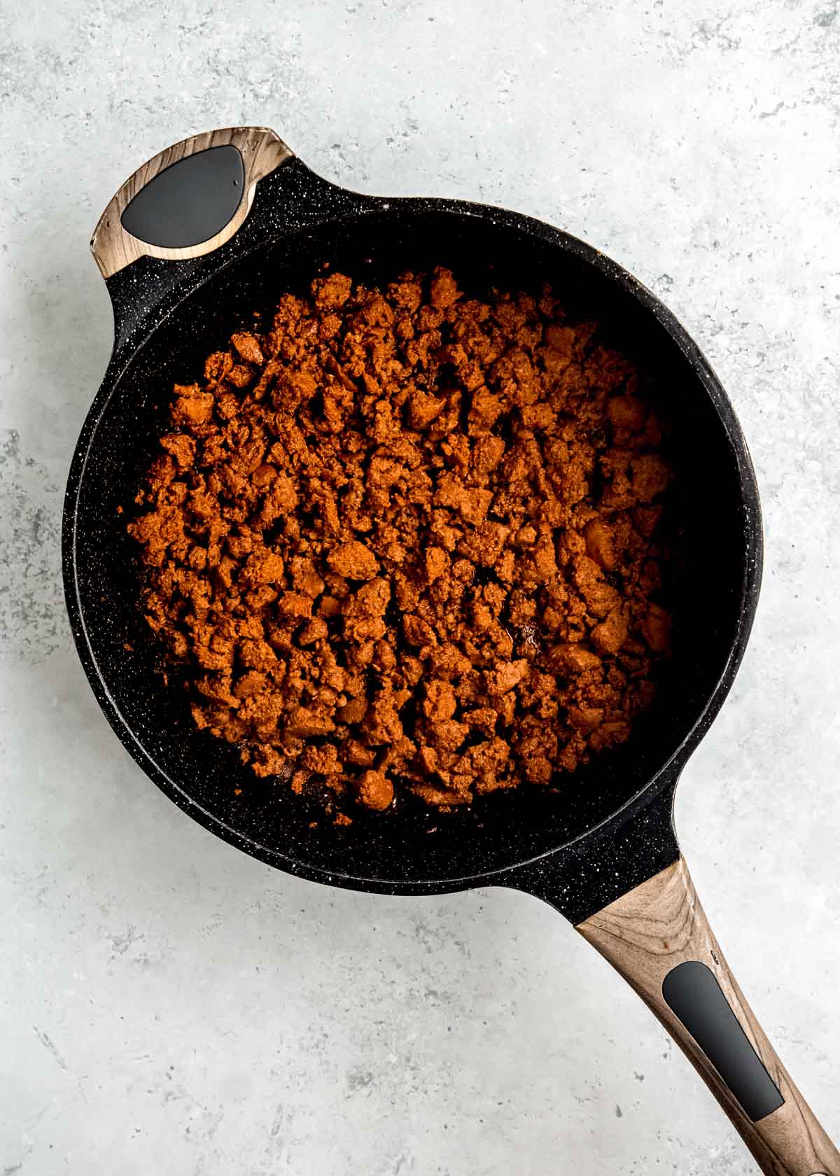ground chorizo cooking in a black skillet