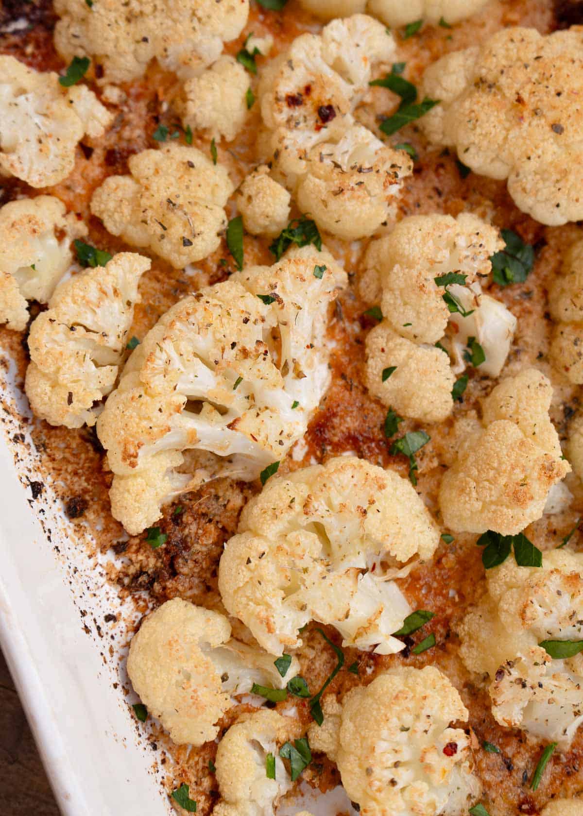 a closeup shot of roasted cauliflower florets with a crispy parmesan crust