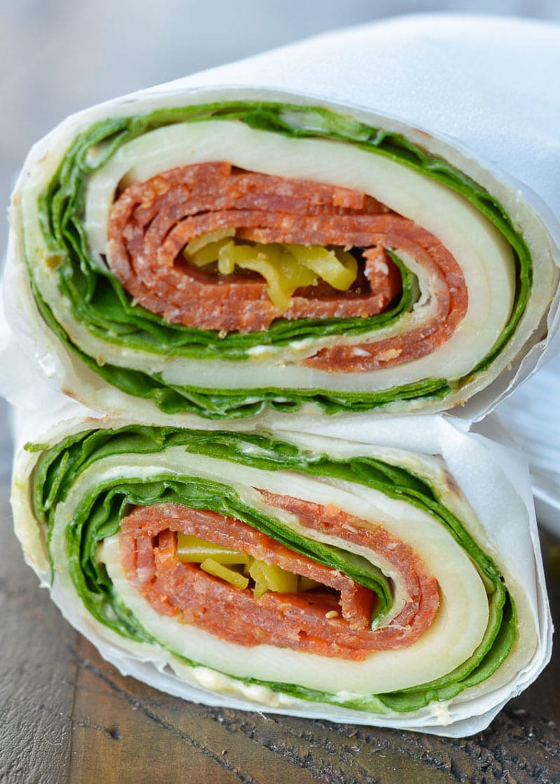 These Pepperoni Cheese Wraps are the perfect keto lunch! Deli pepperoni is paired with smoky provolone, fresh spinach and flavorful pesto aoili, all for about 5 net carbs!