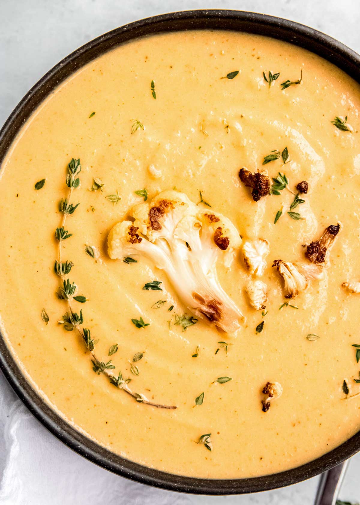 close up of cauliflower soup in black dutch oven