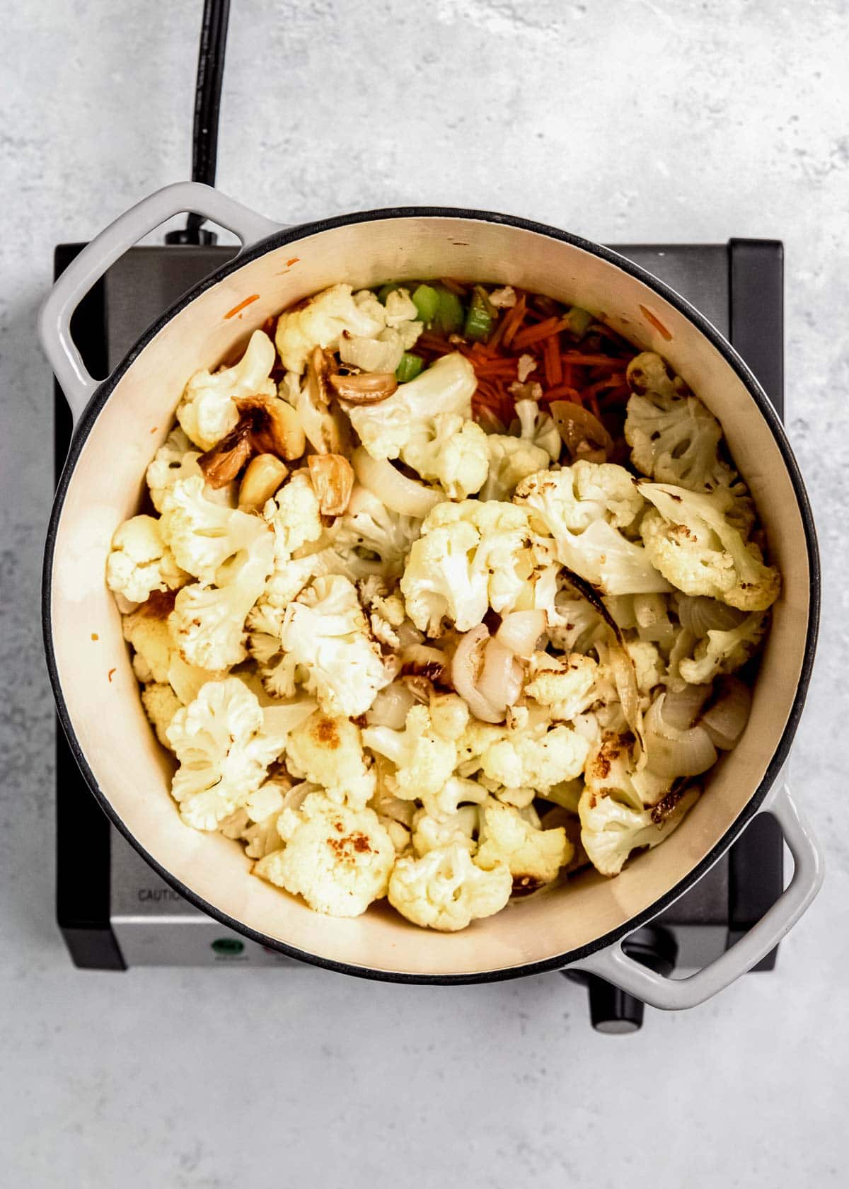 cauliflower soup ingredients in a dutch oven