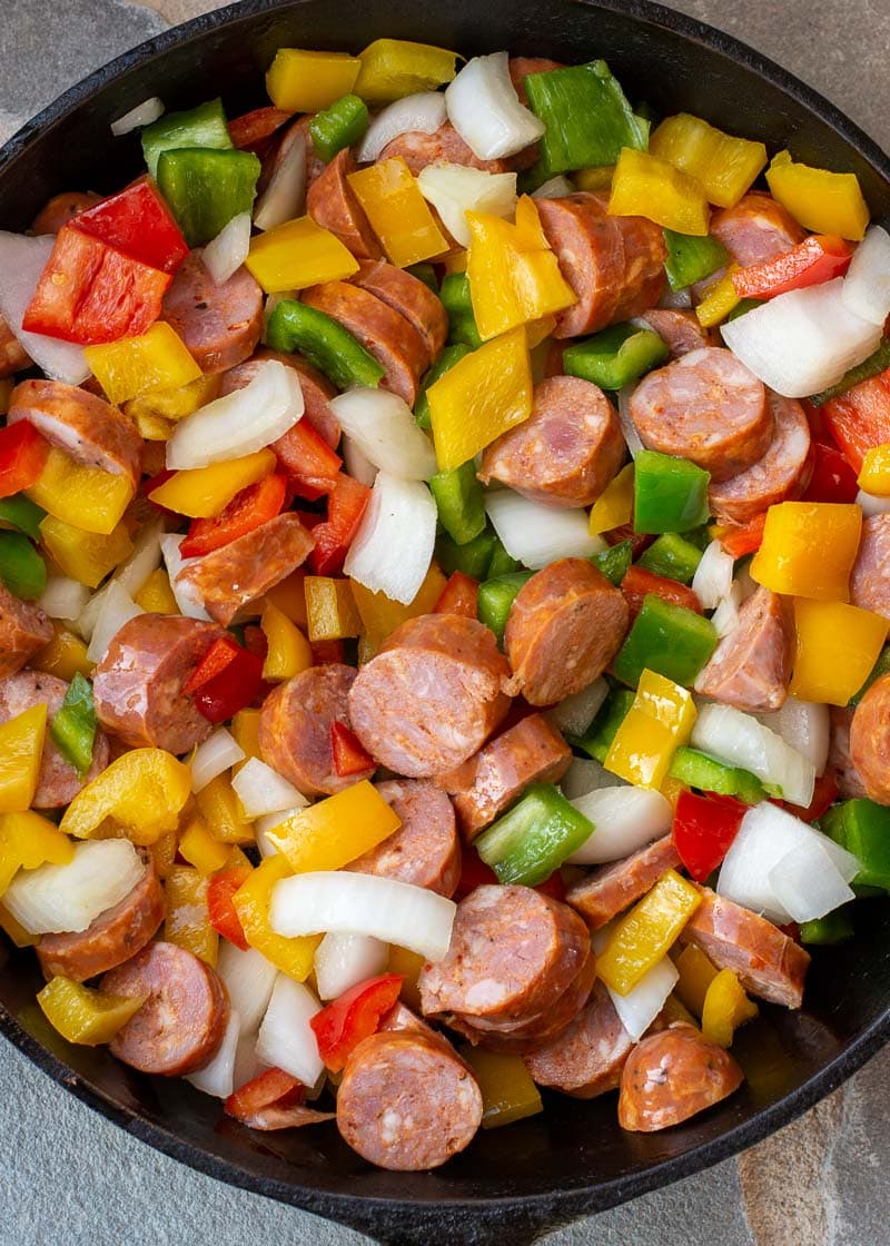 This one pan Sausage and Peppers recipe is perfect for a weeknight meal! Healthy, ready in 15 minutes, 3 ingredients, and under 8 net carbs per serving.