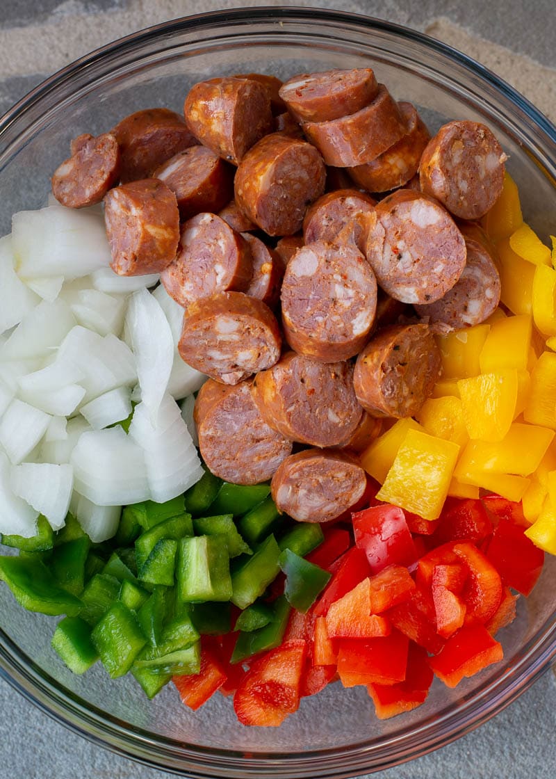 This one pan Sausage and Peppers recipe is perfect for a weeknight meal! Healthy, ready in 15 minutes, 3 ingredients, and under 8 net carbs per serving.