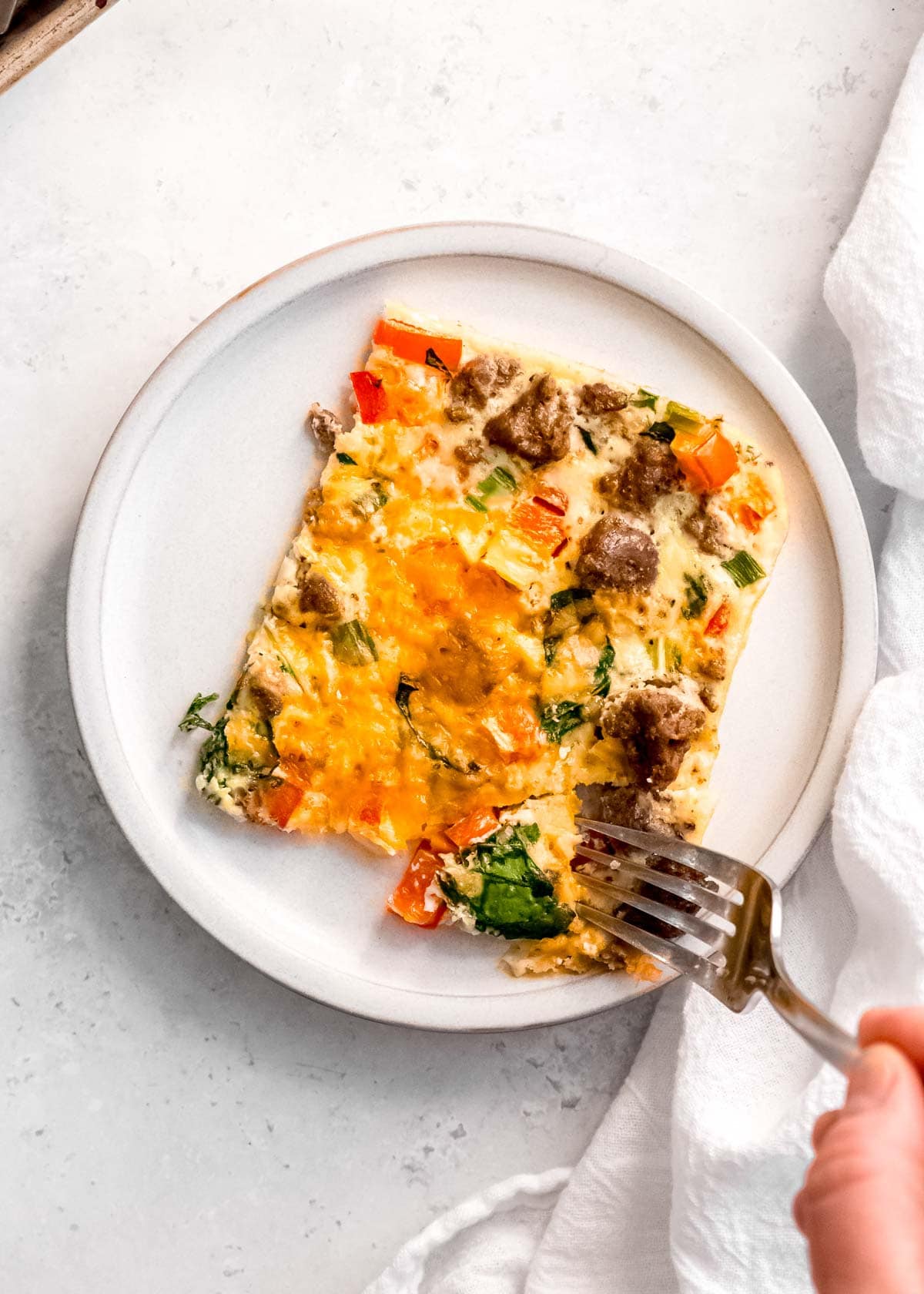 one slice of sheet pan eggs on a white plate