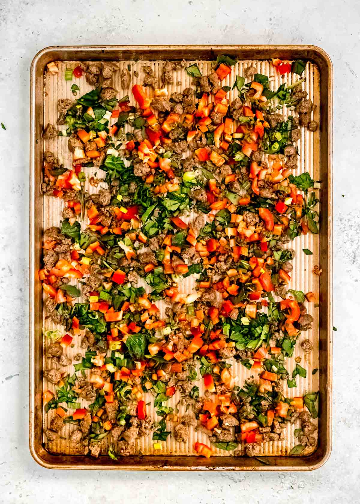 sheet pan egg ingredients being added to baking sheet